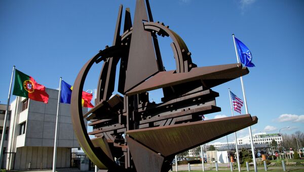 The NATO symbol and flags of the NATO nations outside NATO headquarters in Brussels on Sunday, March 2, 2014 - Sputnik International