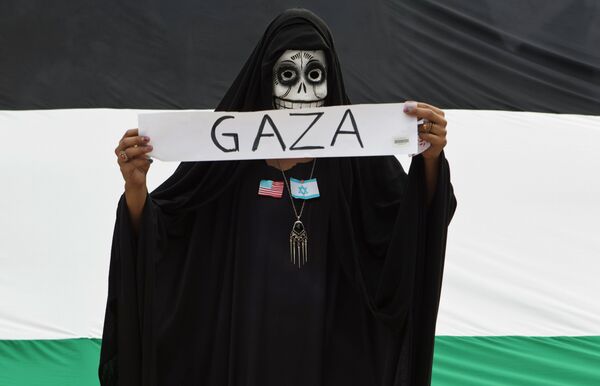 A protester wears a skull face mask during a protest against Israel's military action in the Gaza Strip, in Mexico City, Saturday, Aug. 9, 2014. A protester wears a skull face mask during a protest against Israel's military action in the Gaza Strip, in Mexico City, Saturday, Aug. 9, 2014. - Sputnik International