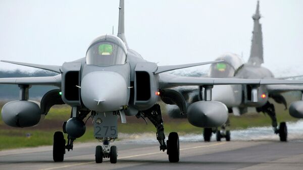 Saab JAS 39 Gripen (Griffin) fighter aircraft taxi out for start during the NATO exercise Loyal Arrow outside Lulea in northern Sweden, on June 10, 2009 - Sputnik International