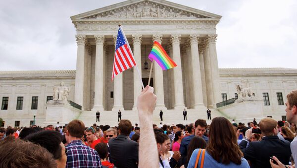 The crowd celebrates outside of the Supreme Court in Washington, Friday June 26, 2015, after the court declared that same-sex couples have a right to marry anywhere in the US - Sputnik International