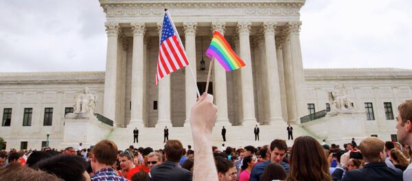 The crowd celebrates outside of the Supreme Court in Washington, Friday June 26, 2015, after the court declared that same-sex couples have a right to marry anywhere in the US - Sputnik International