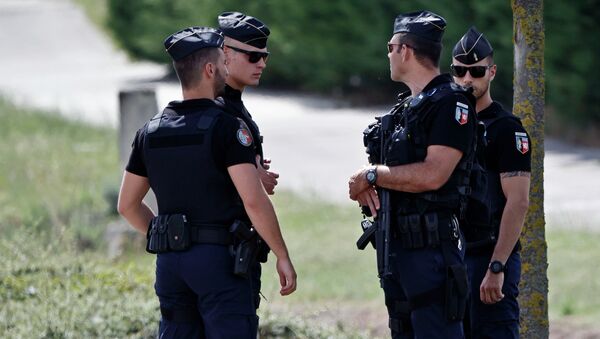 Police officers guard the road leading to a plant where an attack took place in Saint-Quentin-Fallavier, southeast of Lyon, France, Friday, June 26, 2015 - Sputnik International