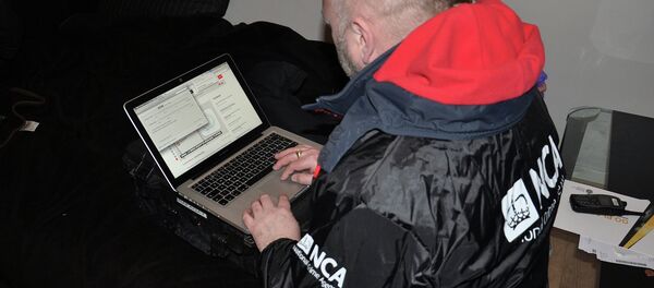 An NCA technical officer triages a seized computer for evidence of criminal activity An NCA technical officer triages a seized computer for evidence of criminal activity - Sputnik International