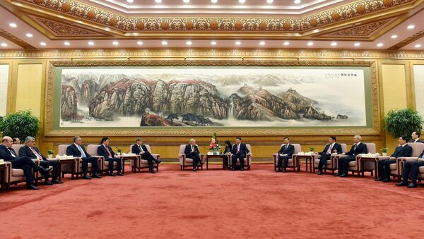 Chinese President Xi Jinping, center right, speaks to Swiss Economy Minister Johann Schneider-Ammann as he meets with delegates attending the signing ceremony for the Articles of Agreement of the Asian Infrastructure Investment Bank (AIIB) at the Great Hall of the People in Beijing - Sputnik International
