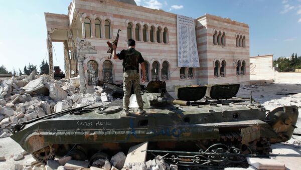 Free Syrian Army soldier stands on a damaged Syrian military tank in front of a damaged mosque, which were destroyed during fighting with government forces, in the Syrian town of Azaz. - Sputnik International