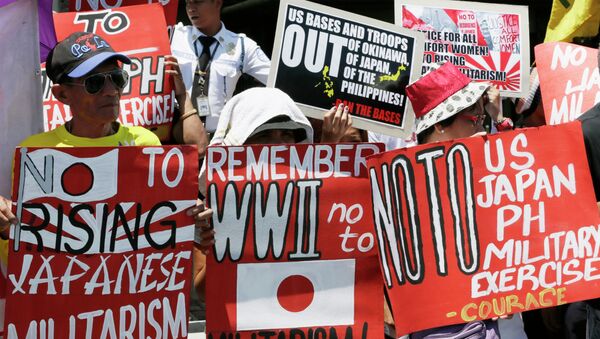 Protesters display placards during a rally outside the Japanese Embassy to protest the ongoing naval exercises by Japan and the United States. - Sputnik International