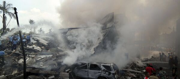Firemen and security forces attempt to extinguish the fire surrounding the wreckage of an Indonesian military transport plane after it crashed in the North Sumatra city of Medan, Indonesia June 30, 2015 in this photo taken by Antara Foto Firemen and security forces attempt to extinguish the fire surrounding the wreckage of an Indonesian military transport plane after it crashed in the North Sumatra city of Medan, Indonesia June 30, 2015 in this photo taken by Antara Foto - Sputnik International