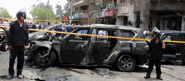 Policemen secure the site of a car bomb attack on the convoy of Egyptian public prosecutor Hisham Barakat near his house at Heliopolis district in Cairo, Egypt, June 29, 2015 Policemen secure the site of a car bomb attack on the convoy of Egyptian public prosecutor Hisham Barakat near his house at Heliopolis district in Cairo, Egypt, June 29, 2015 - Sputnik International