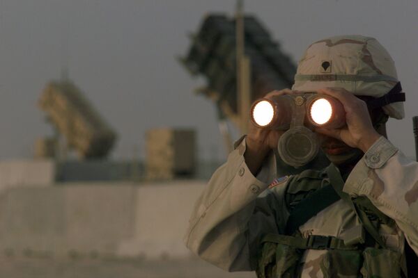 US soldier uses a pair of binoculars to scans the landscape around his Patriot Missiles based at Al Udeid AB, Qatar US soldier uses a pair of binoculars to scans the landscape around his Patriot Missiles based at Al Udeid AB, Qatar - Sputnik International