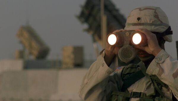 US soldier uses a pair of binoculars to scans the landscape around his Patriot Missiles based at Al Udeid AB, Qatar - Sputnik International