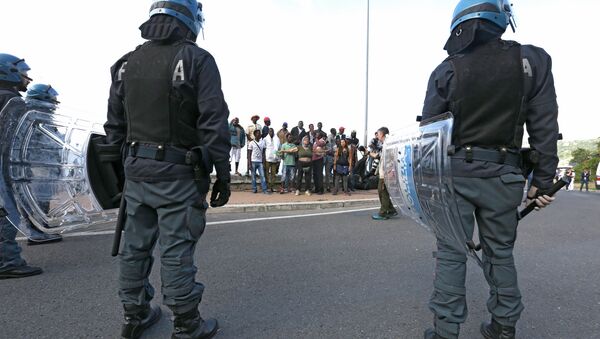 Italian policemen stand in front of migrants at the Franco-Italian border near Menton, southeastern France, Tuesday, June 16, 2015 - Sputnik International
