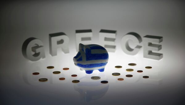 A piggybank painted in the colours of the Greek flag stands amongst various euro coins in front of letters spelling the word 'GREECE' in this picture illustration taken in Berlin, Germany June 30, 2015 - Sputnik International