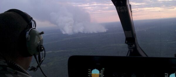 An aerial view from a helicopter shows smoke from forest fires some 40 km from Chernobyl nuclear power plant in Kiev region, northern Ukraine, June 29, 2015. Picture taken with a mobile phone on June 29, 2015 - Sputnik International