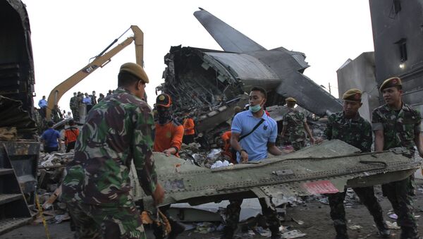 Indonesian soldiers and rescue teams remove debris from the wreckage of a military C-130 transport plane which crashed yesterday into a residential area in Medan, North Sumatra, Indonesia July 1, 2015 in this photo taken by Antara Foto - Sputnik International
