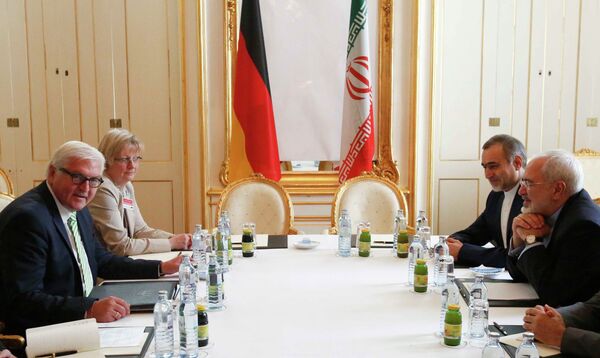 German Foreign Minister Frank-Walter Steinmeier (L) and Iranian Foreign Minister Javad Zarif wait for the start of a bilateral meeting in Palais Coburg, the venue for nuclear talks in Vienna, Austria, July 2, 2015 German Foreign Minister Frank-Walter Steinmeier (L) and Iranian Foreign Minister Javad Zarif wait for the start of a bilateral meeting in Palais Coburg, the venue for nuclear talks in Vienna, Austria, July 2, 2015 - Sputnik International