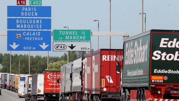 Trucks are stuck in a traffic jam on a highway leading to the Channel tunnel after striking workers invaded the Eurotunnel train tracks in Calais, northern France, in a protest against job cuts, 30 June 2015. - Sputnik International