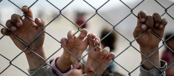 Hands of Syrian Kurdish children are seen holding a fence in a UNHCR (United Nations Refugee Agency) refugee camp on February 2, 2015, at Suruc, in Sanliurfa Hands of Syrian Kurdish children are seen holding a fence in a UNHCR (United Nations Refugee Agency) refugee camp on February 2, 2015, at Suruc, in Sanliurfa - Sputnik International