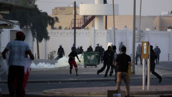 Bahraini anti-government protesters clash with riot police firing tear gas in front of a police station Saturday, Dec. 31, 2011, in the western Shiite Muslim village of Karzakan, Bahrain - Sputnik International