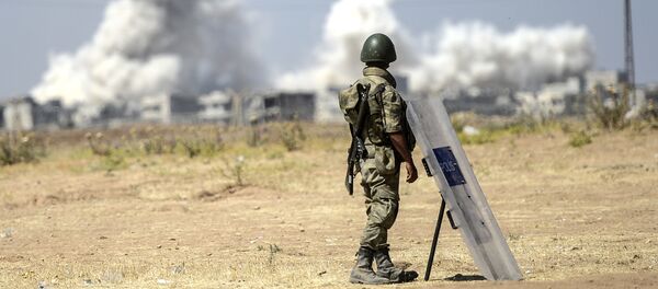 A picture taken from the Turkish side of the border in Suruc, Sanliurfa province, shows a Turkish solider standing as smoke rises from the Syrian town of Kobane, also known as Ain al-Arab, on June 27, 2015 A picture taken from the Turkish side of the border in Suruc, Sanliurfa province, shows a Turkish solider standing as smoke rises from the Syrian town of Kobane, also known as Ain al-Arab, on June 27, 2015 - Sputnik International