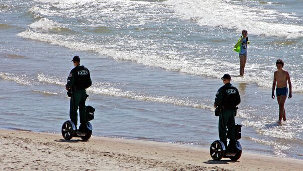 Police officers ride Segway scooters as they patrol the seaside resort of Palanga, Lithuania - Sputnik International