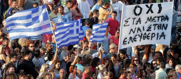 Demonstrators wave greek flags during an anti-austerity rally in front of the parliament building in Athens, Greece, July 3, 2015 Demonstrators wave greek flags during an anti-austerity rally in front of the parliament building in Athens, Greece, July 3, 2015 - Sputnik International