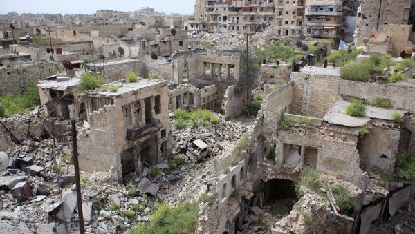 A general view shows destruction in the Hamidiyeh neighbourhood of the northern Syrian city of Aleppo as local popular committee fighters, who support the Syrian government forces, try to defend the traditionally Christian district on the third day of intense battles with Islamic State group jihadists on April 9, 2015 - Sputnik International