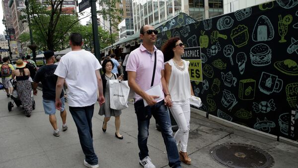 Newlyweds Valasia Limnioti, right, and Konstantinos Patronis walk in Midtown Manhattan, Thursday, July 2, 2015, in New York. The couple topped the dream trip of our lives in New York City, where their three-week honeymoon turned into a nightmare: Their Greek-issued credit cards were suddenly declined and they were left nearly penniless. Strangers from two Greek Orthodox churches in Queens came to their rescue, giving them survival cash until their flight home to Greece this Friday. - Sputnik International