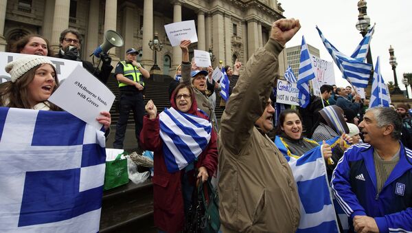 Protestors wave the Greek flag as they shout Oxi (No) during the Melbourne stands with Greece solidarity rally outside Parliament House in Melbourne on July 4, 2015 - Sputnik International