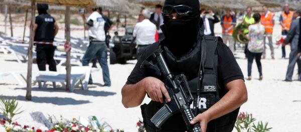 A hooded Tunisian police officer stands guard ahead of the visit of top security officials of Britain, France, Germany and Belgium at the scene of Friday's shooting attack in front of the Imperial Marhaba hotel in the Mediterranean resort of Sousse, Tunisa, Monday, June 29, 2015 A hooded Tunisian police officer stands guard ahead of the visit of top security officials of Britain, France, Germany and Belgium at the scene of Friday's shooting attack in front of the Imperial Marhaba hotel in the Mediterranean resort of Sousse, Tunisa, Monday, June 29, 2015 - Sputnik International