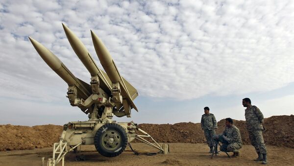In this Nov. 13, 2012 file photo obtained from the Iranian Mehr News Agency, Iranian army members prepare missiles to be launched, during a maneuver, in an undisclosed location in Iran - Sputnik International