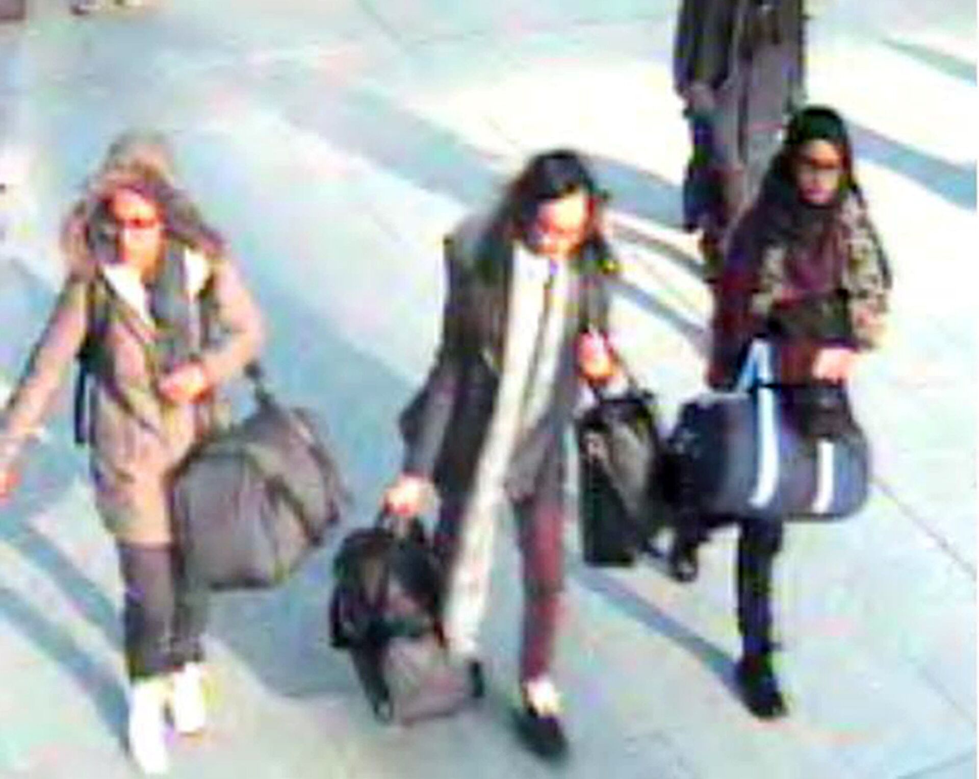  Amira Abase, left, Kadiza Sultana, center, and Shamima Begum, walk through Gatwick airport, south of London, before catching their flight to Turkey on Tuesday Feb 17, 2015 - Sputnik International, 1920, 12.06.2022