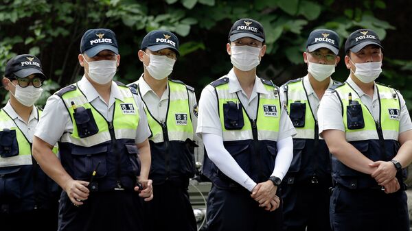 Police officers wearing masks as a precaution against Middle East Respiratory Syndrome (MERS) stand guard during a rally in Seoul, South Korea - Sputnik International