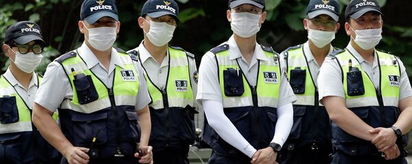 Police officers wearing masks as a precaution against Middle East Respiratory Syndrome (MERS) stand guard during a rally in Seoul, South Korea - Sputnik International