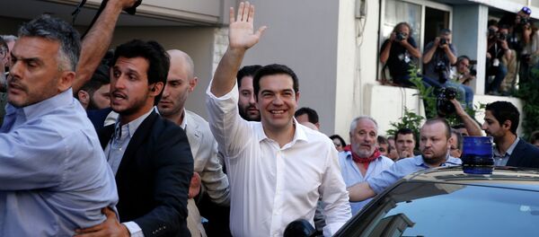 Greece's Prime Minister Alexis Tsipras waves to his supporters after voting outside a polling station in Athens, Sunday, July 5, 2015 Greece's Prime Minister Alexis Tsipras waves to his supporters after voting outside a polling station in Athens, Sunday, July 5, 2015 - Sputnik International