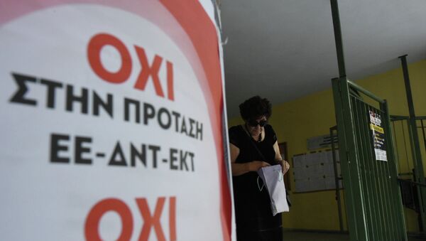 An elderly woman leaves from a polling station as the poster reading ''No to the proposal of EU-IMF-ECB'' in the northern Greek port city of Thessaloniki, Sunday, July 5, 2015 - Sputnik International