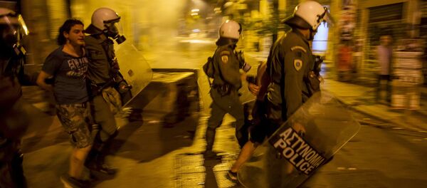 Riot police detain a youth during minor clashes in central Athens, Greece July 5, 2015 Riot police detain a youth during minor clashes in central Athens, Greece July 5, 2015 - Sputnik International
