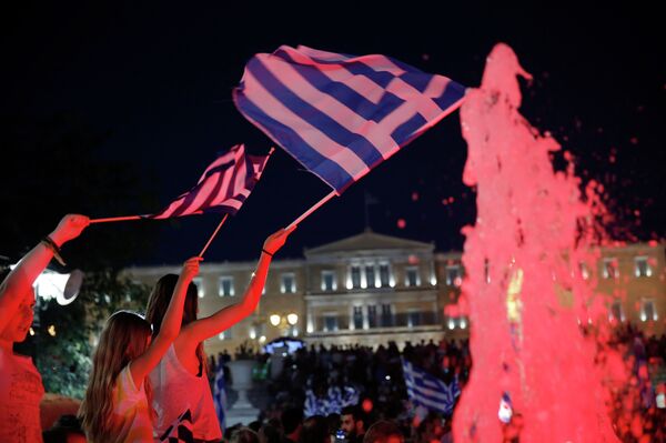 Young girls wave Greek flags as supporters of the No vote react after the first results of the referendum at Syntagma square in Athens, Sunday, July 5, 2015. Young girls wave Greek flags as supporters of the No vote react after the first results of the referendum at Syntagma square in Athens, Sunday, July 5, 2015. - Sputnik International