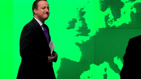 Britain's Prime Minister David Cameron walks past a map of Europe on a screen. - Sputnik International