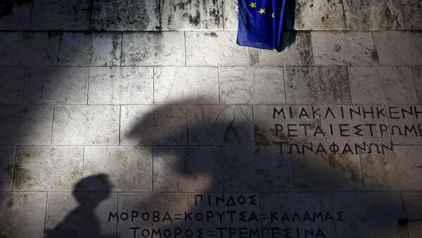 An European Union flag is pictured as people are silhouetted on the Tomb of the Unknown Soldier during a rally in front of the Greek parliament - Sputnik International