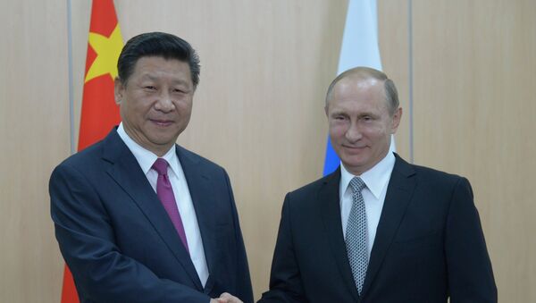 President of the Russian Federation Vladimir Putin (right) and President of the People’s Republic of China Xi Jinping during their meeting in Ufa. - Sputnik International