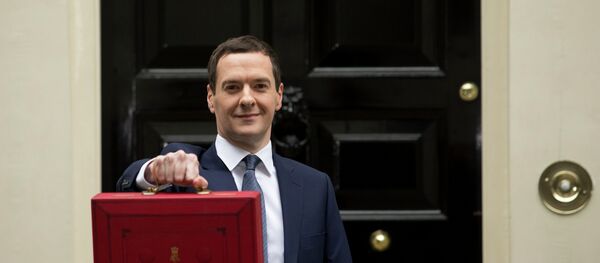 British Chancellor of the Exchequer George Osborne poses for the media with the traditional red dispatch box outside his official residence, 11 Downing Street in London, prior to unveiling the budget, Wednesday, July 8, 2015. - Sputnik International