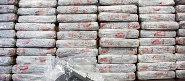 A firearm and 154 pounds of heroin worth at least $50 million are displayed at a Drug Enforcement Administration news conference. A firearm and 154 pounds of heroin worth at least $50 million are displayed at a Drug Enforcement Administration news conference. - Sputnik International