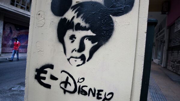 In this photo made on Thursday, June 18, 2015 a man walks behind a stencil depicting German Chancellor Angela Merkel as a Disney character in Athens - Sputnik International