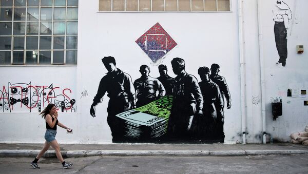 In this photo taken on Wednesday, June 17, 2015, a woman walks past a graffiti artwork titled Death of Euros made by French street artist Goin at the Athens School of Fine Arts - Sputnik International