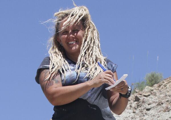Wendy Sloboda stands over a bonebed containing the Wendiceratops pinhornenis dinosaur in Manyberries, Alberta in an undated photo released by the Cleveland Museum of Natural History - Sputnik International