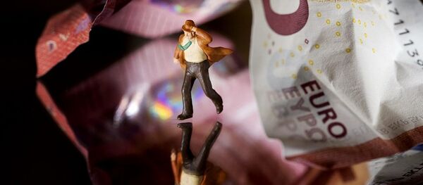 This illustration picture taken in Paris on July 7, 2015 shows a plastic figurine set in the motion of running from underneath a 10 Euro note. - Sputnik International