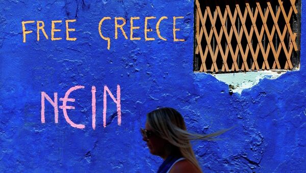 A tourist passes a graffiti in the Plaka tourist district of Athens, Greece - Sputnik International