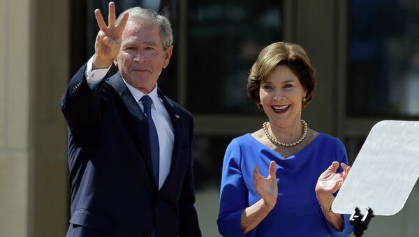 Former President George W. Bush, accompanied by his wife former first lady Laura Bush, flashes the W sign after his speech during the dedication of the George W. Bush Presidential Center - Sputnik International