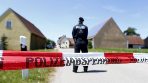 A police tape and a German police officer are seen in Tiefenthal near Ansbach, Germany, July 10, 2015 - Sputnik International