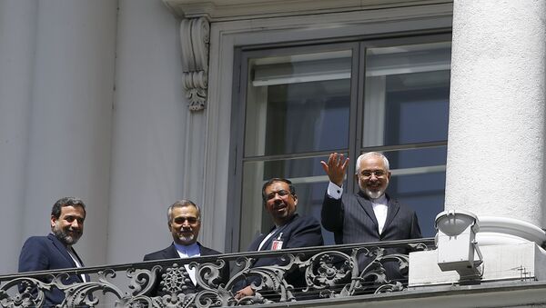 Iranian Foreign Minister Javad Zarif (R) listens to questions from journalists as he stands next to Iran's chief nuclear negotiator Abbas Araghchi (L) and Hossein Fereydoon (2nd L), brother and close aide to President Hassan Rouhani, on the balcony of Palais Coburg, the venue for nuclear talks in Vienna, Austria, July 10, 2015 - Sputnik International
